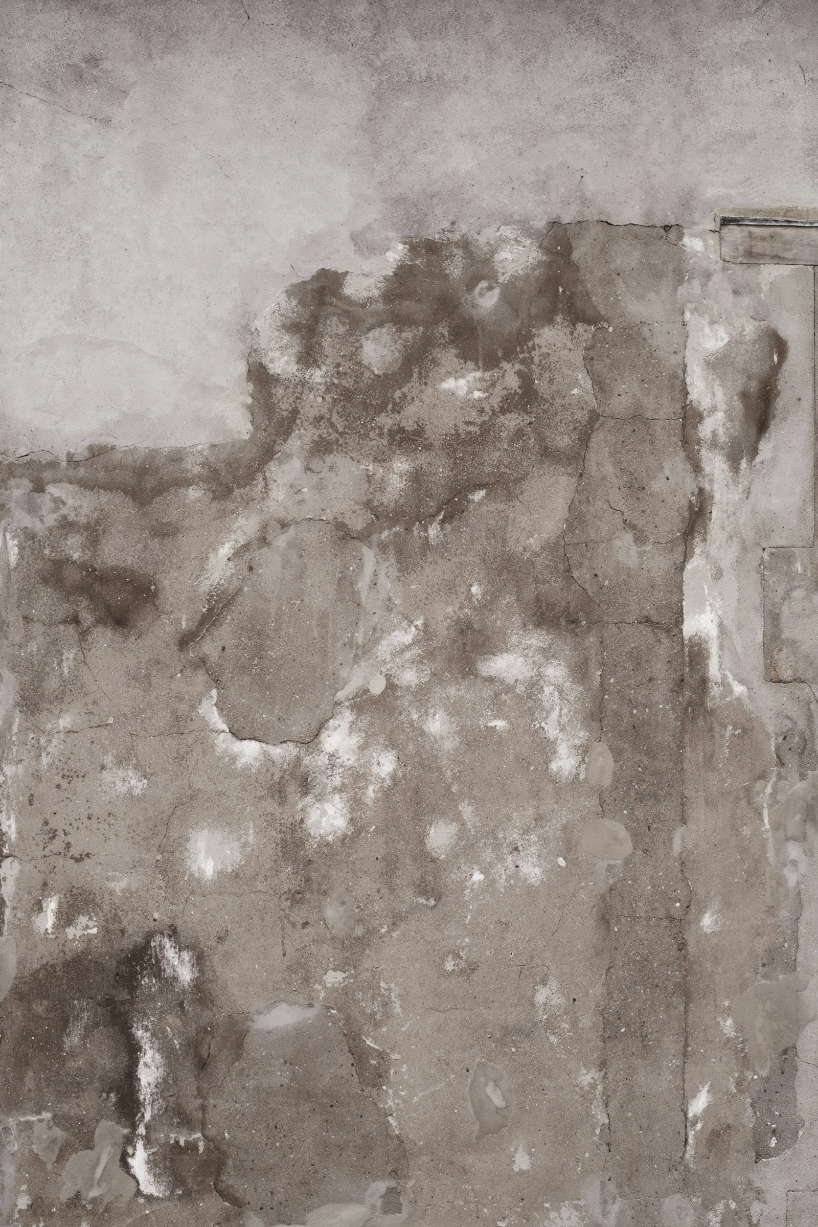 Wall with water stains, cracks, and damaged surface finish